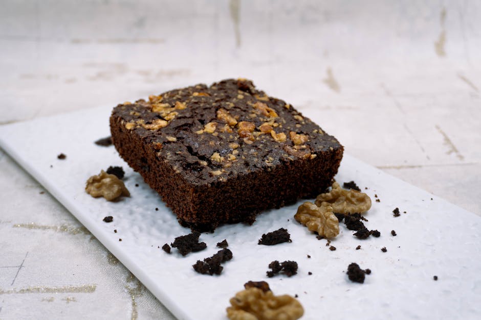 A rich chocolate brownie topped with walnuts, perfect for dessert lovers.